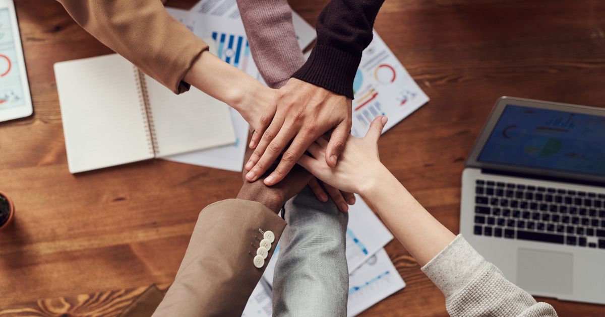 Successful business technology team avoiding common software mistakes through proper planning and senior development expertise